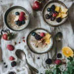 Creamy quinoa pudding topped with berries and coconut flakes in a glass bowl